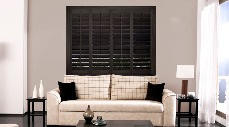 Sacramento living room with stained wood shutters.